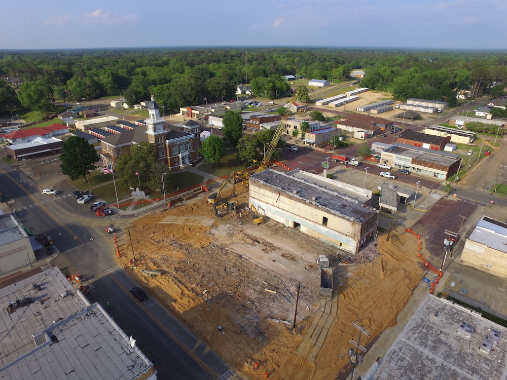 An aerial view of a construction site with trees in the background.