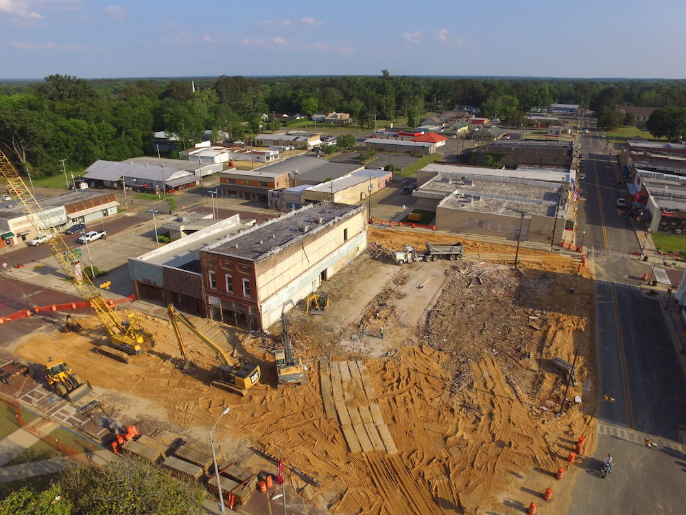 A construction site with many buildings and trees.