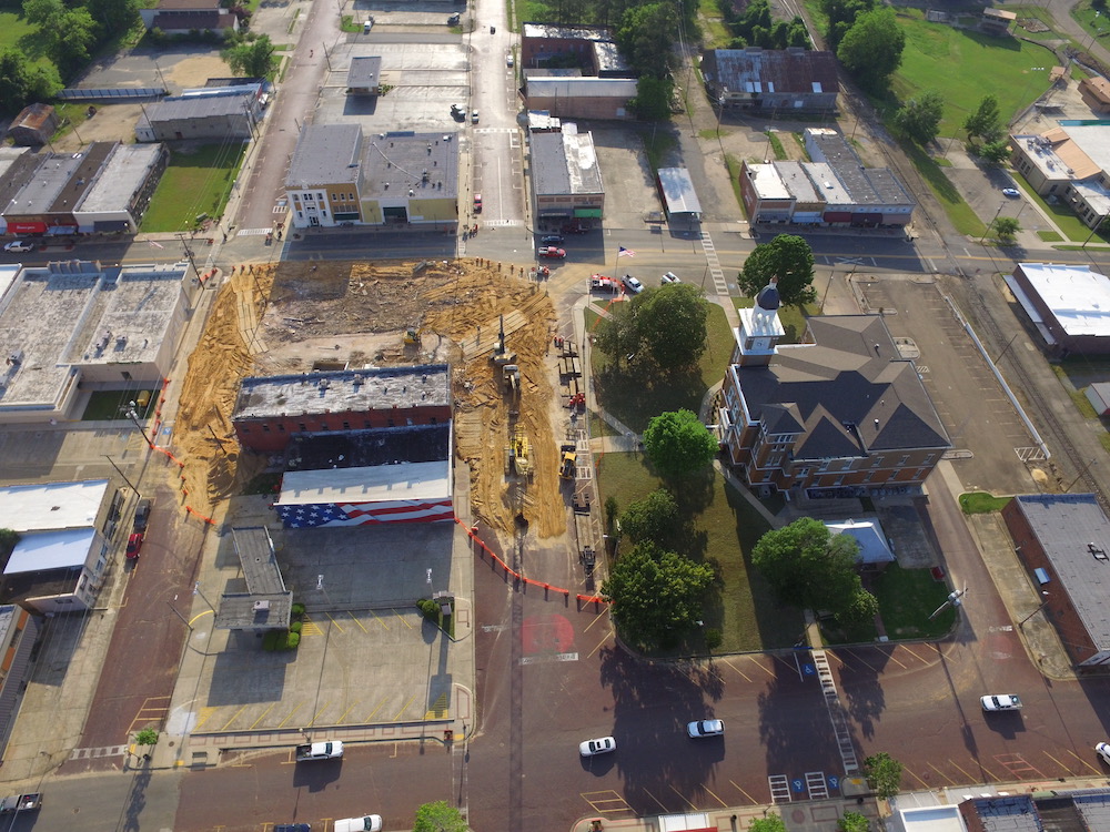An aerial view of a construction site in the middle of a city.