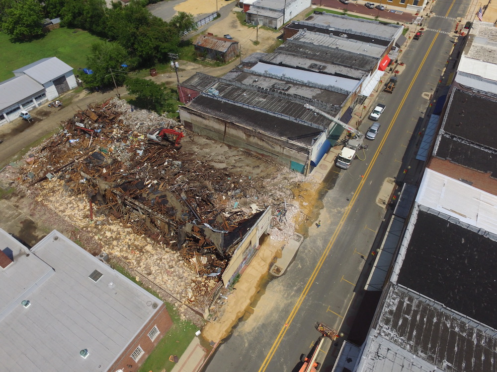 An aerial view of a building being demolished.