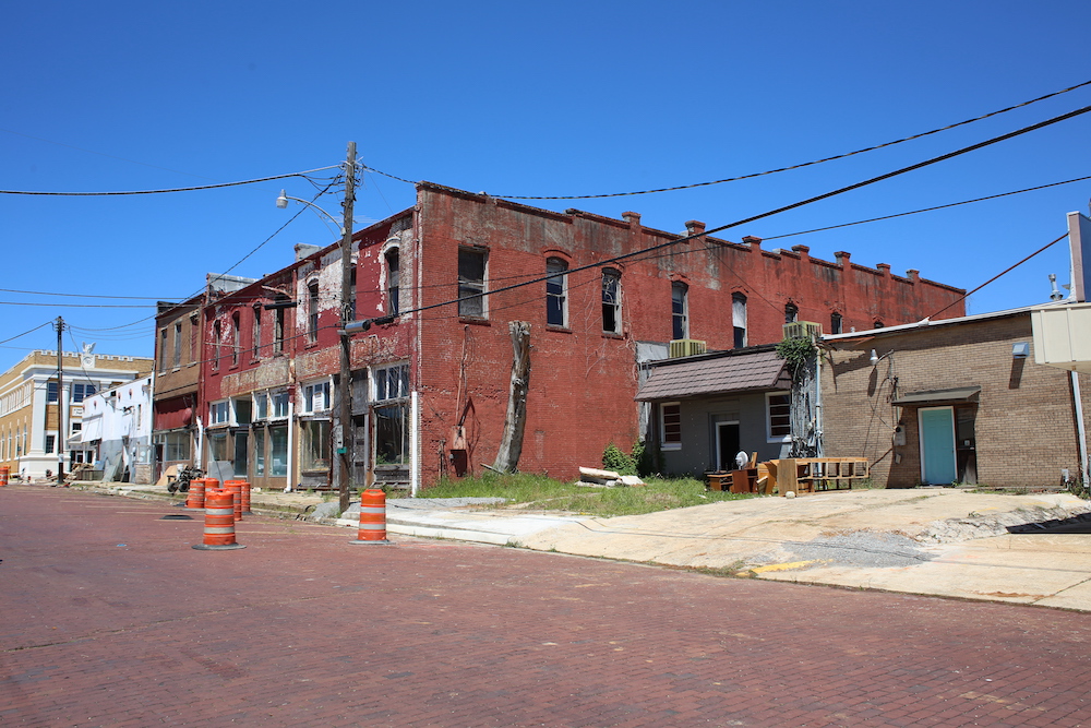 A red brick building with some orange construction cones