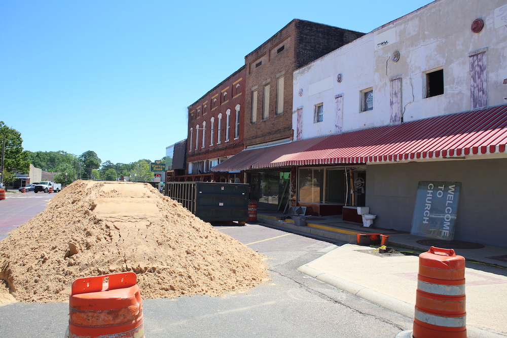 A street with a pile of dirt on the side.