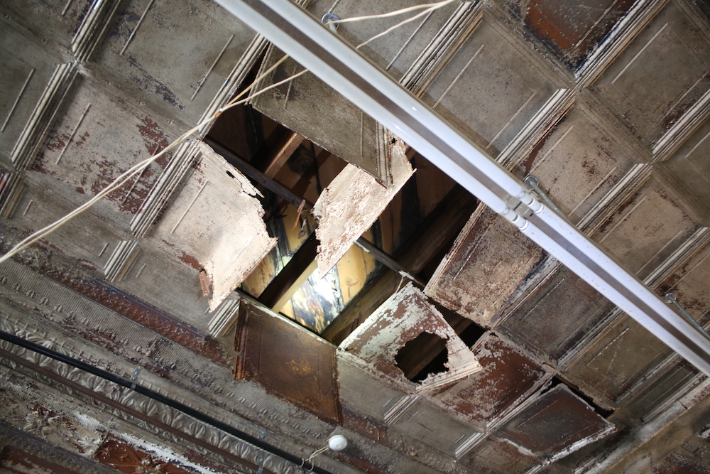 A hole in the ceiling of an unfinished building.