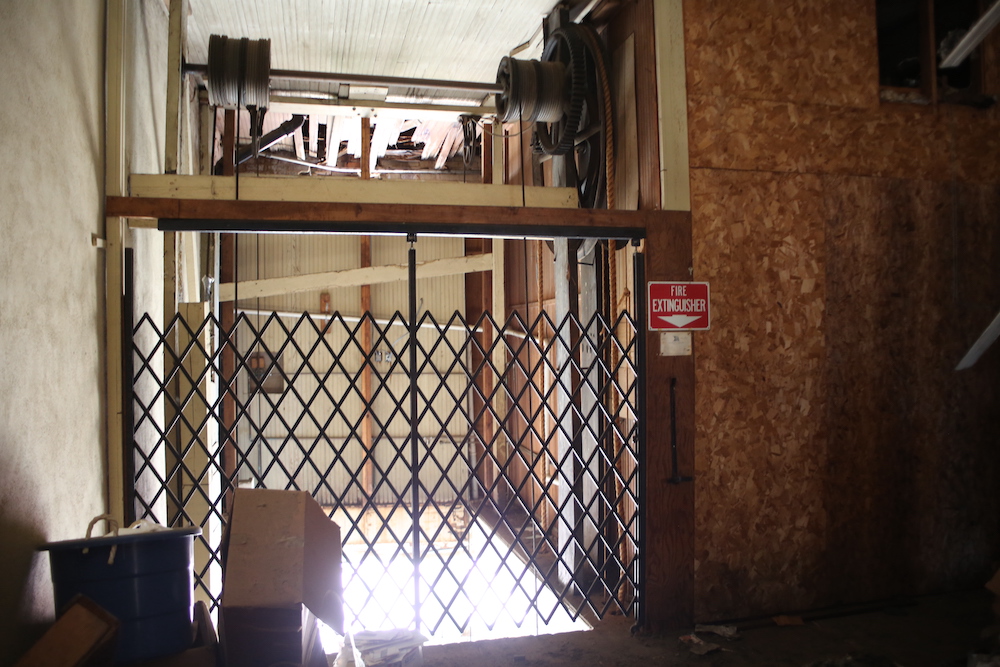 A room with a metal gate and some boxes