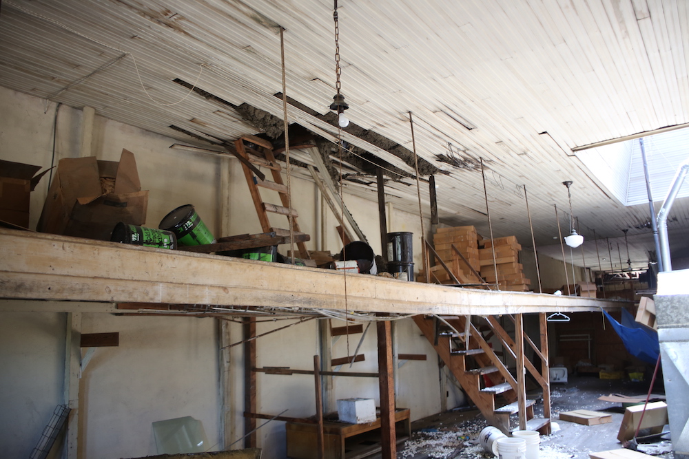 A room with several stairs and some wood.