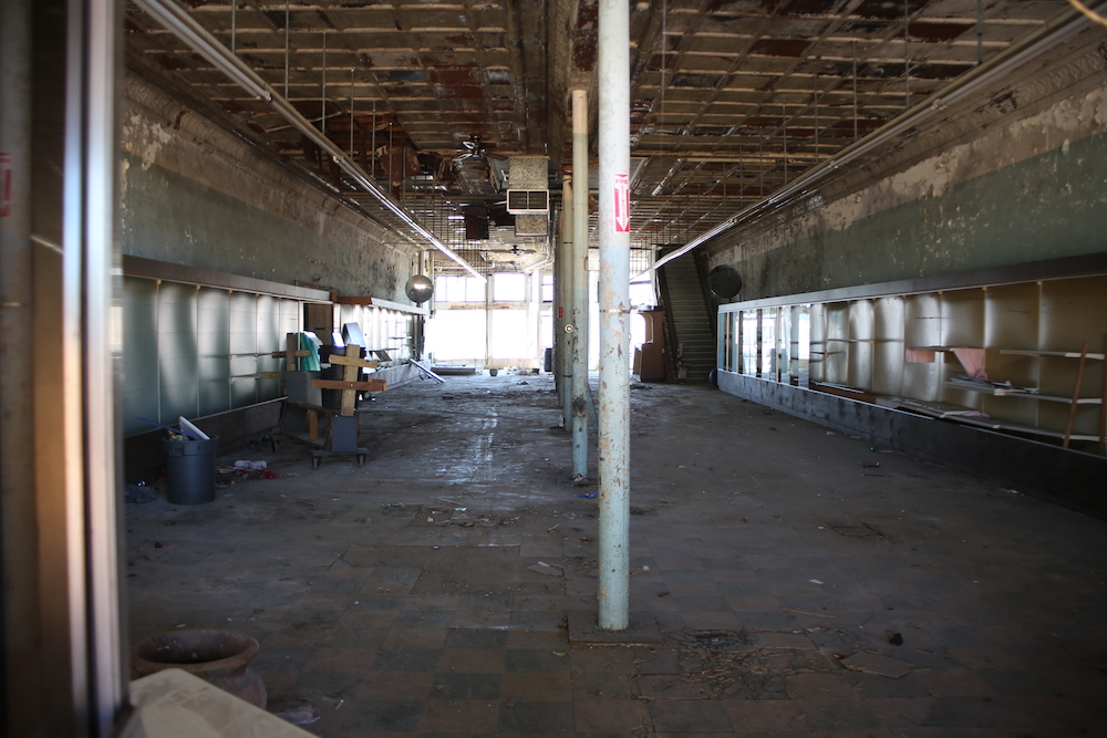 A large empty room with many windows and a ceiling.