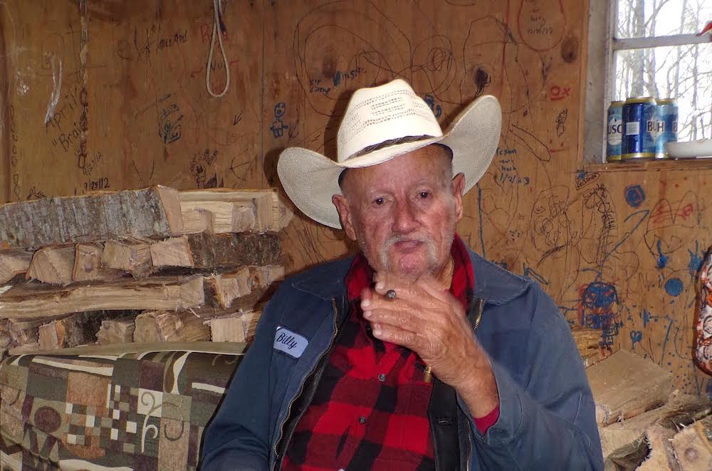 A man in a cowboy hat is talking to someone.