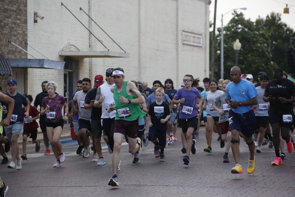 A group of people running in the street