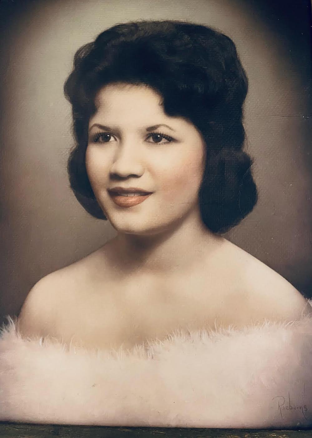 A woman in a white dress and black hair.