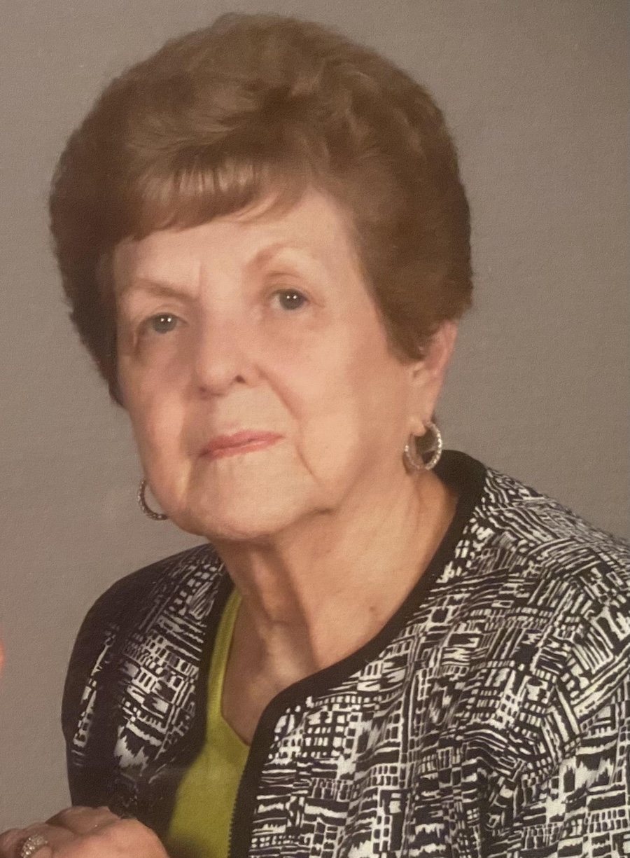 A woman with short hair and wearing a black jacket.