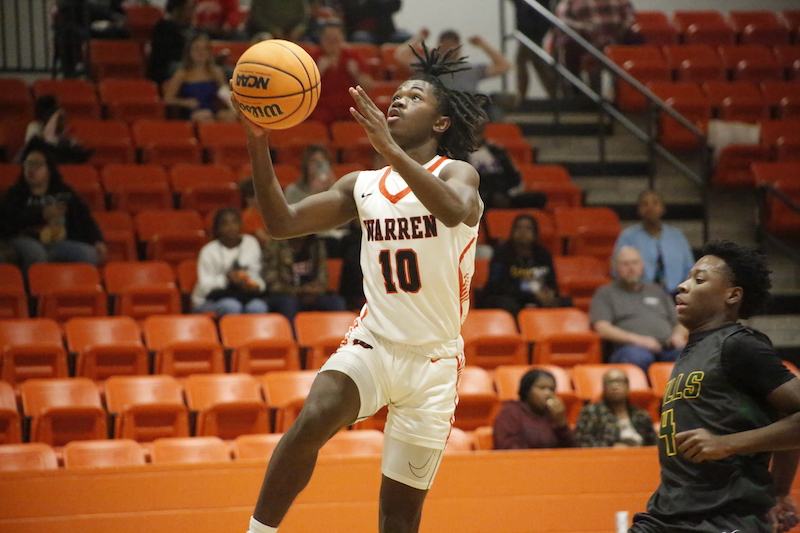 A man in white shorts holding a basketball.