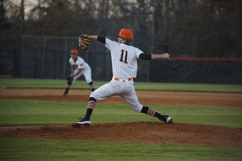 A baseball player is throwing the ball to another player.