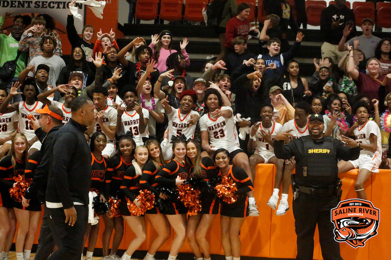 A group of cheerleaders and fans in the stands.