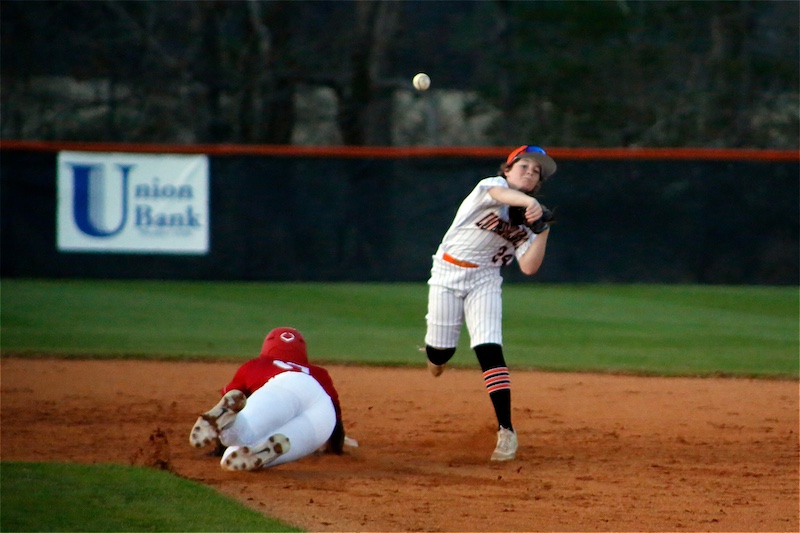 A baseball player is about to catch the ball.