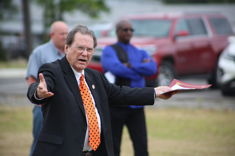 A man in a suit and tie holding something