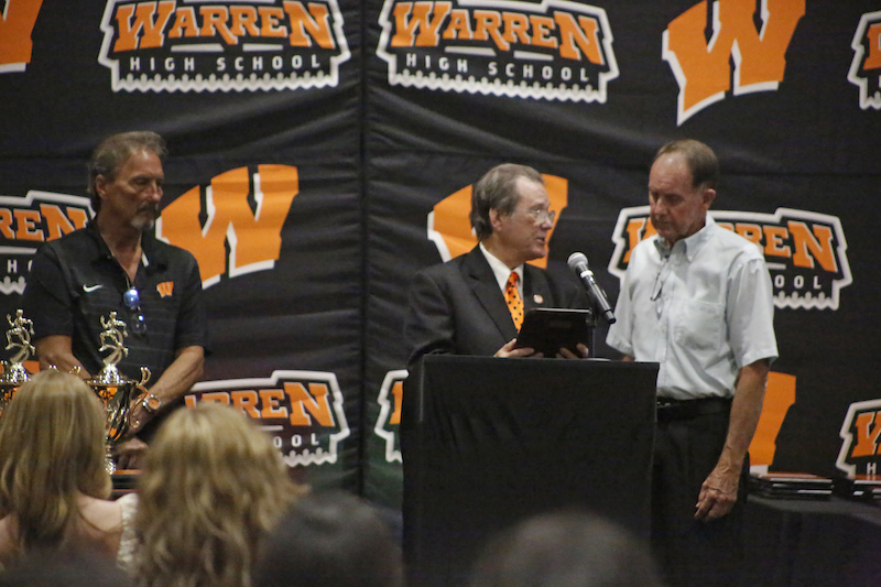 A group of people standing around a podium.