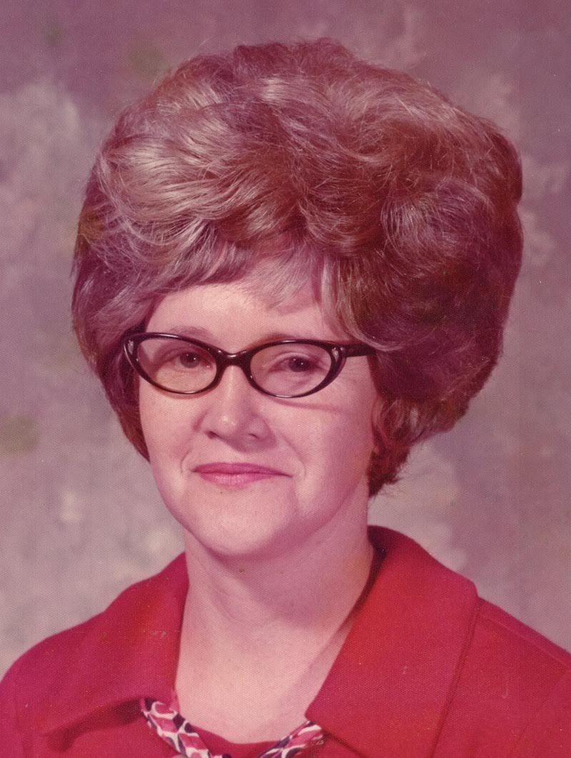 A woman with glasses and a red shirt