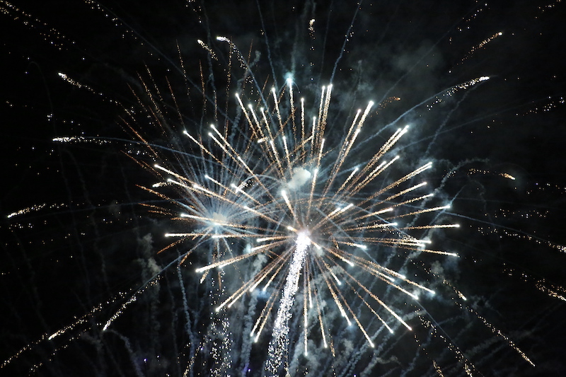 A fireworks display with lots of white and blue lights.