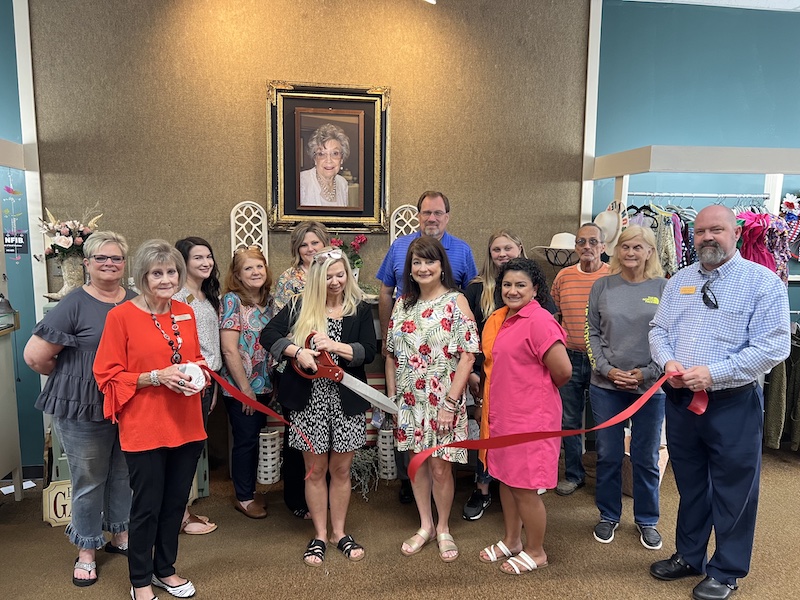 A group of people standing in front of a painting.