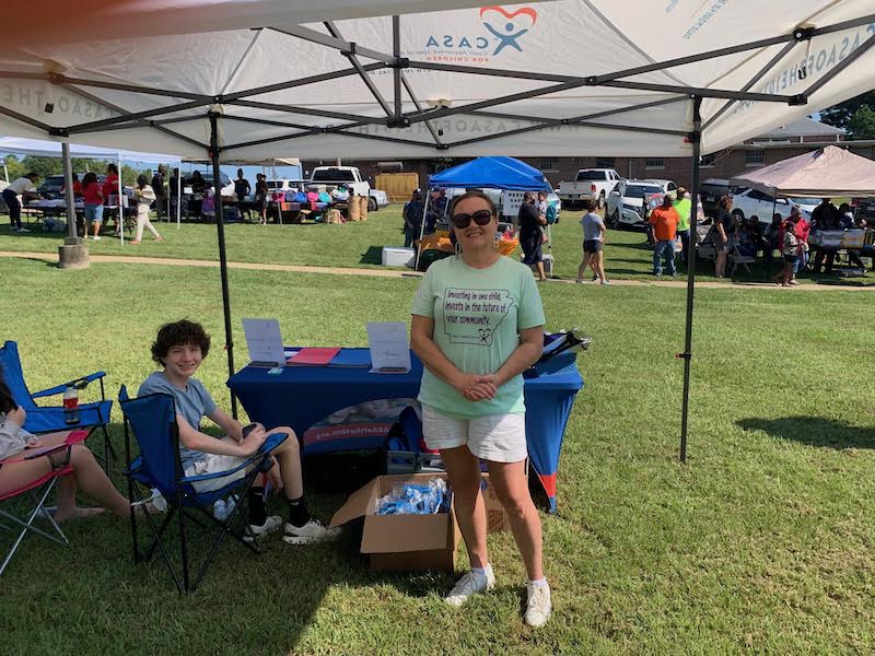A group of people sitting under a tent.