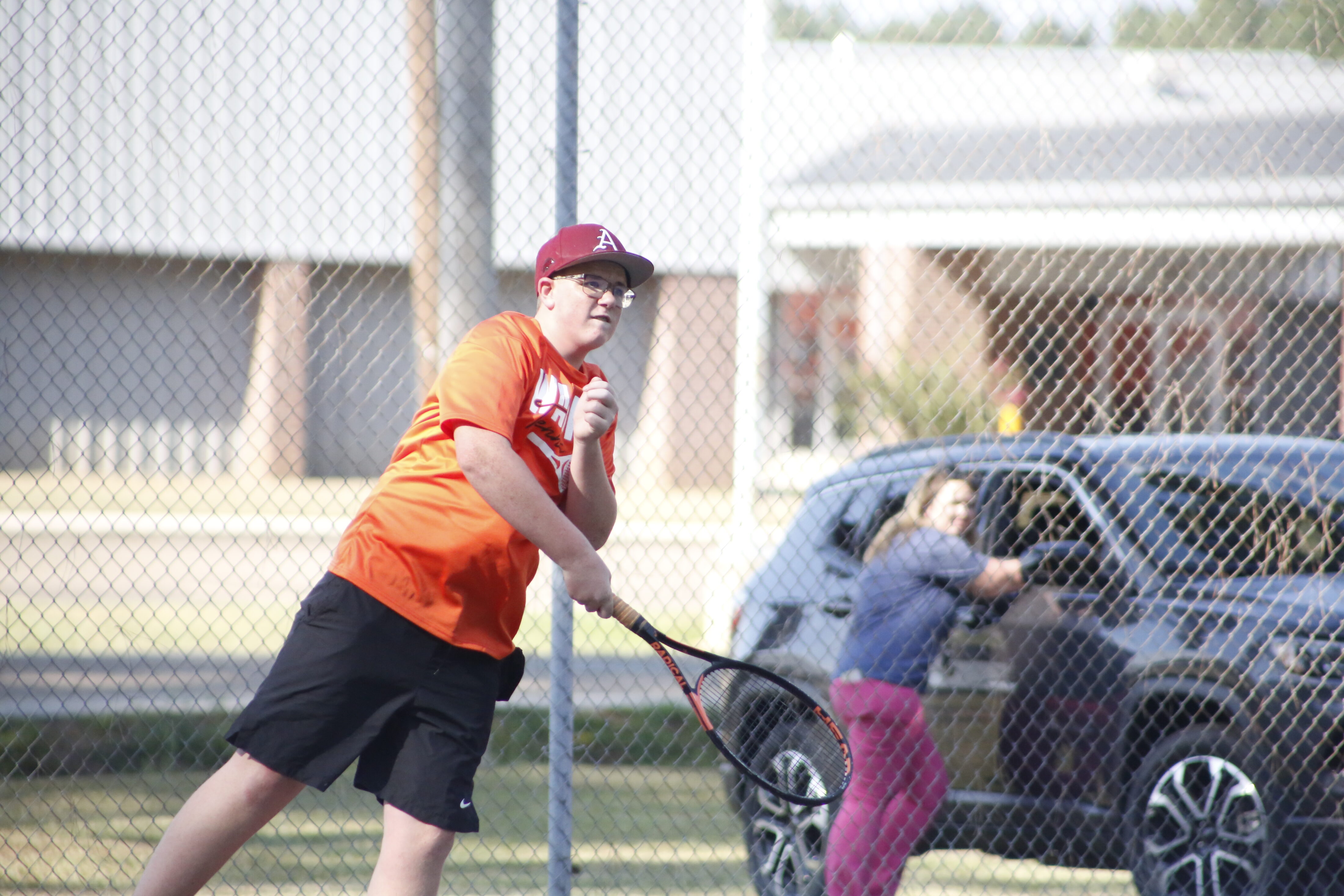 A man swinging a tennis racket at a ball