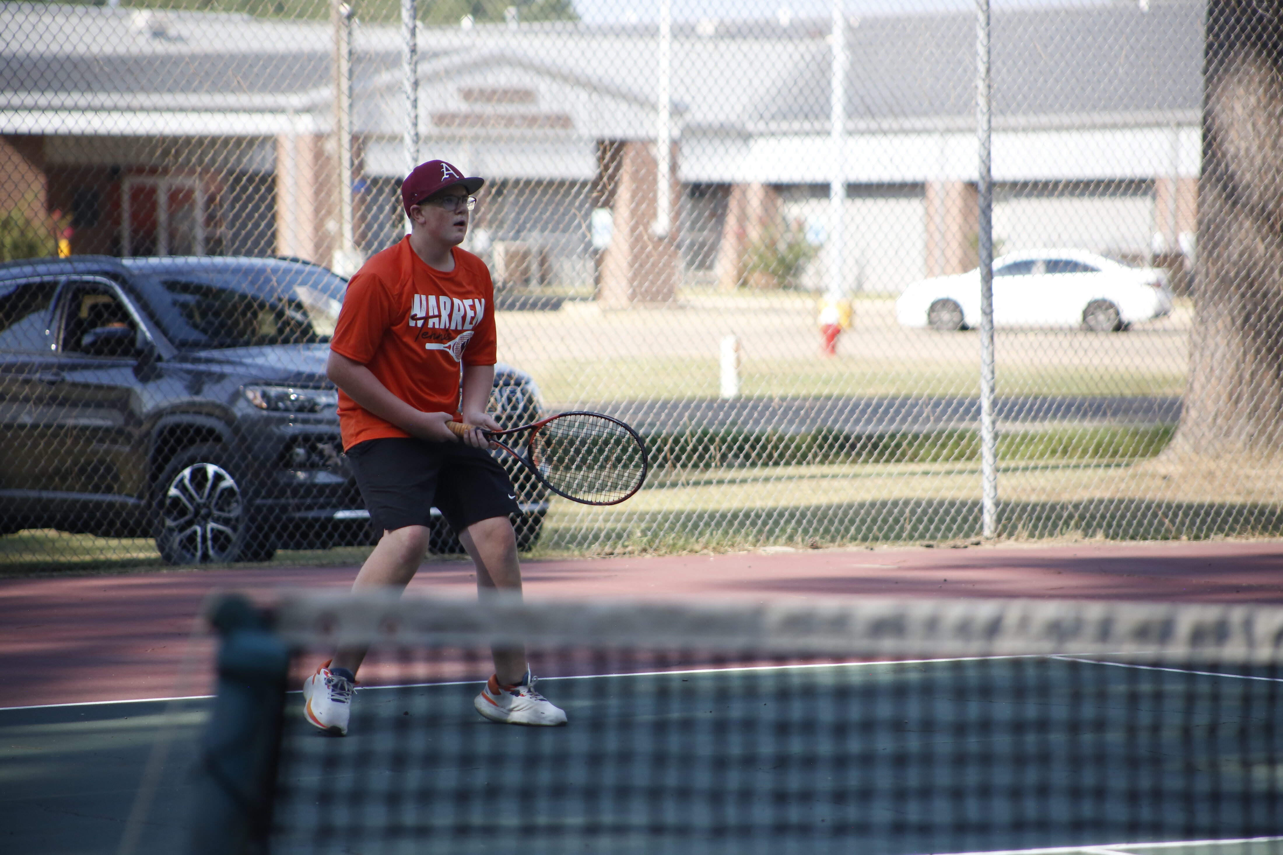 A man holding a tennis racket on the court