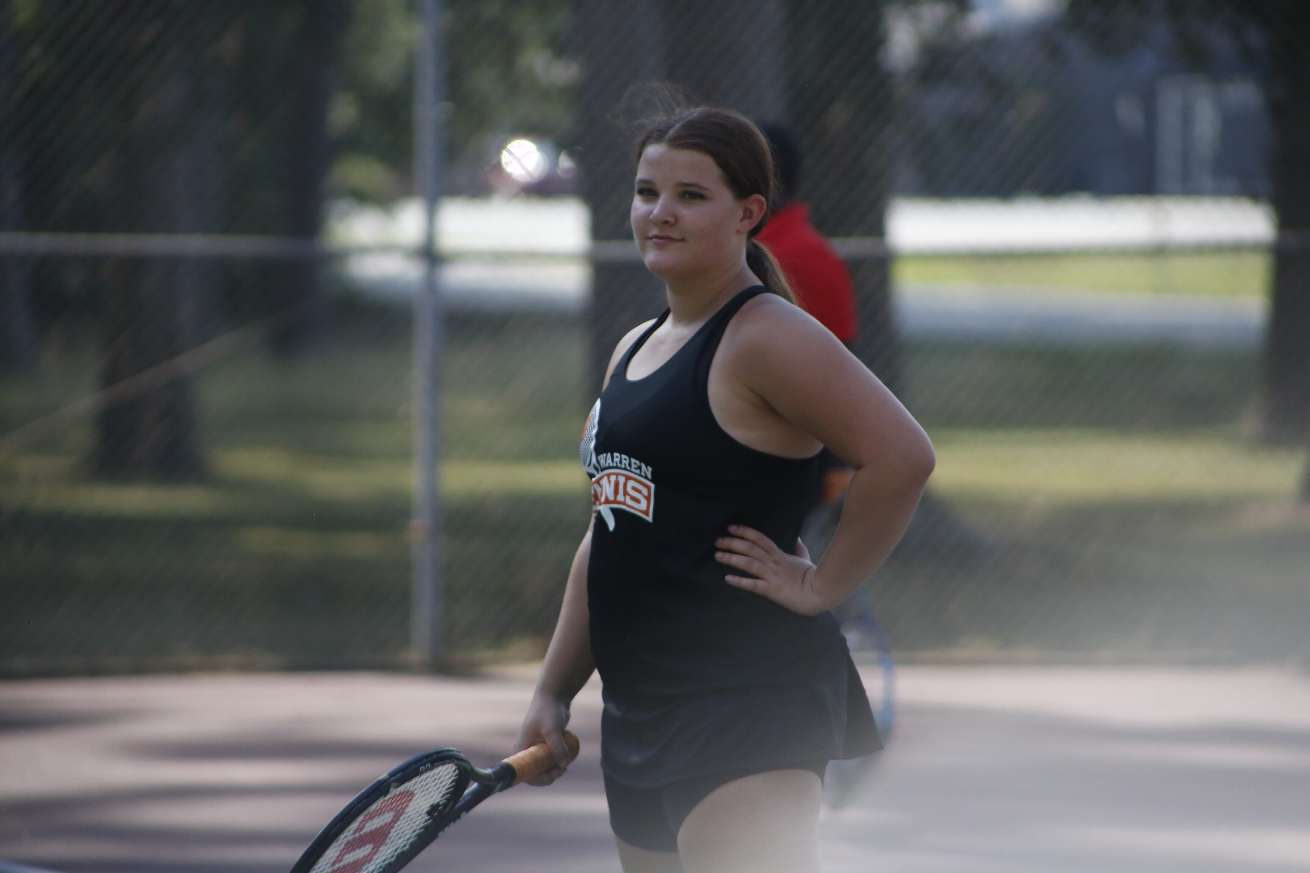 A woman holding a tennis racket on the court