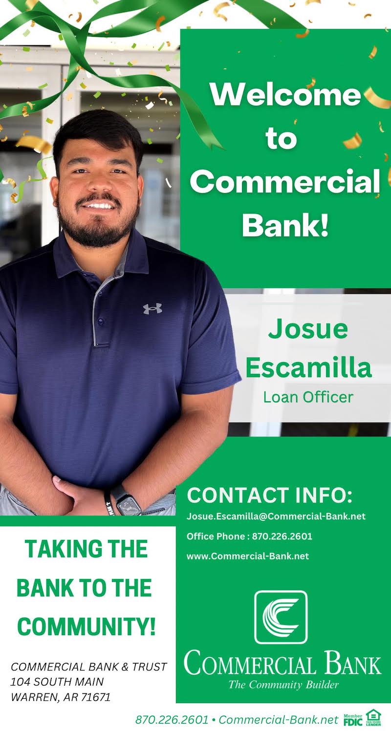 A man standing in front of a commercial bank sign.