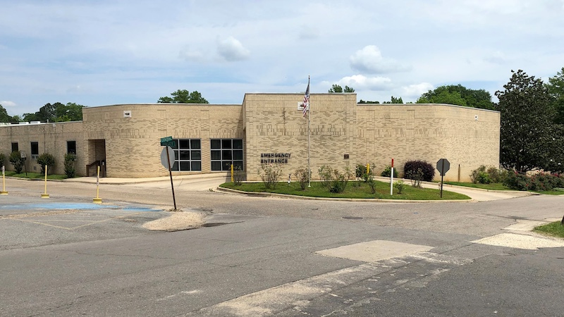 A large building with a parking lot in front of it.