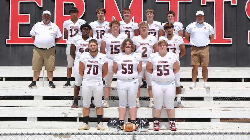 A football team is posing for the camera.