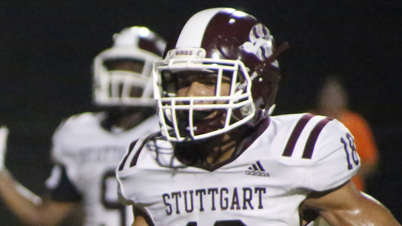 A football player wearing a helmet and uniform.