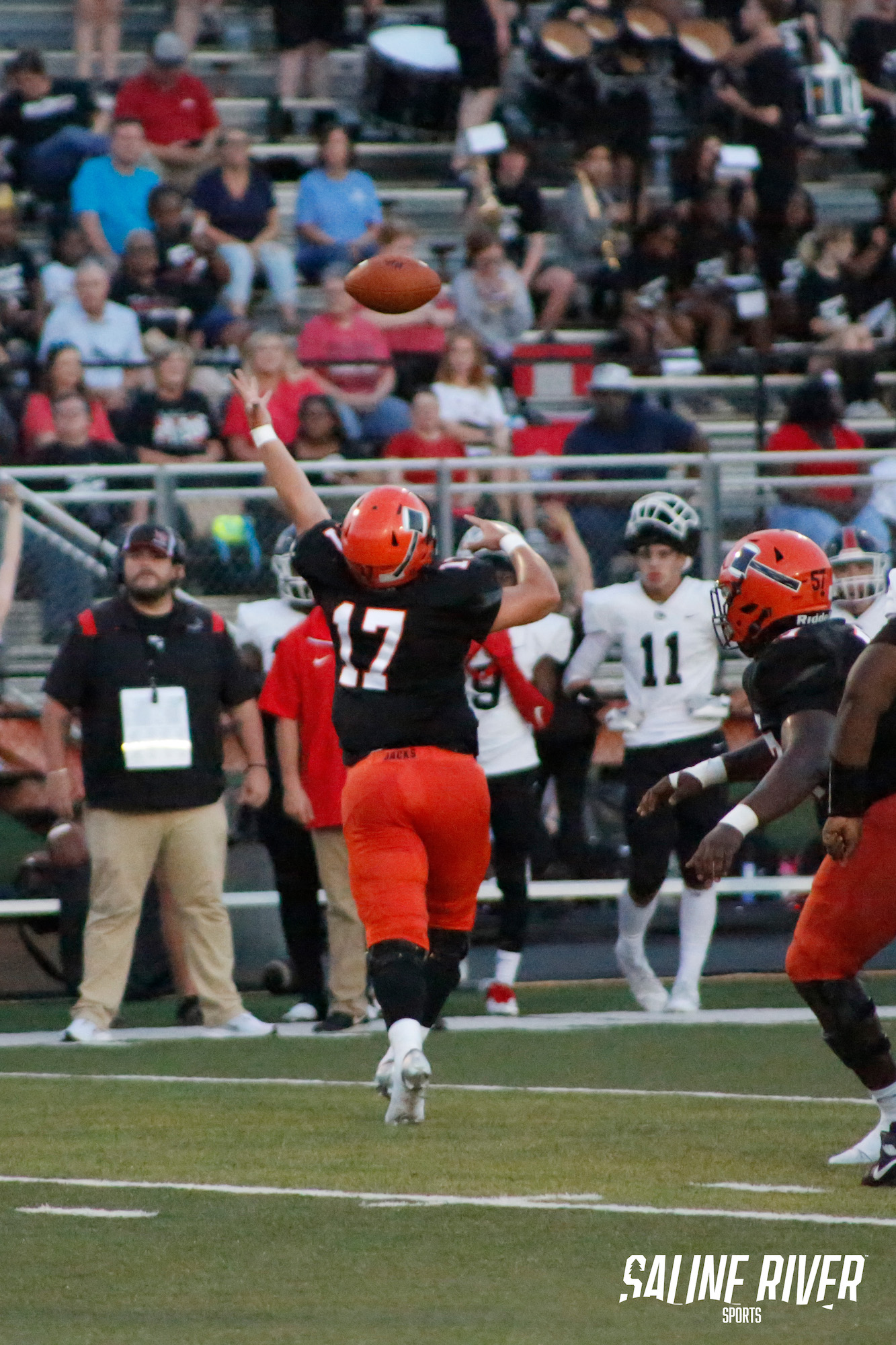 A football player is throwing the ball to another team.