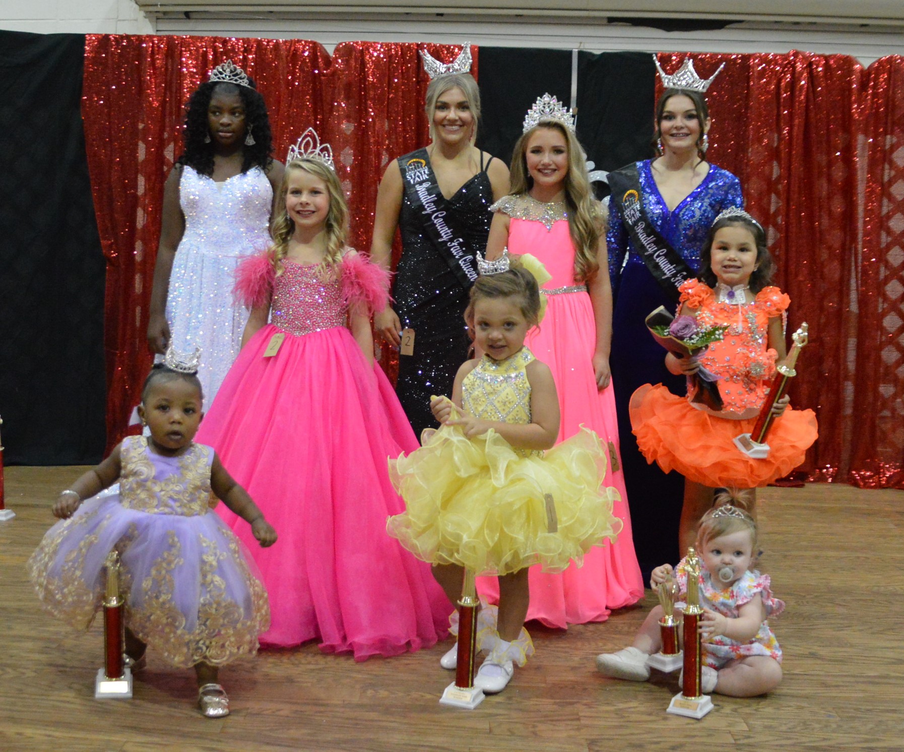 A group of people that are standing up in dresses