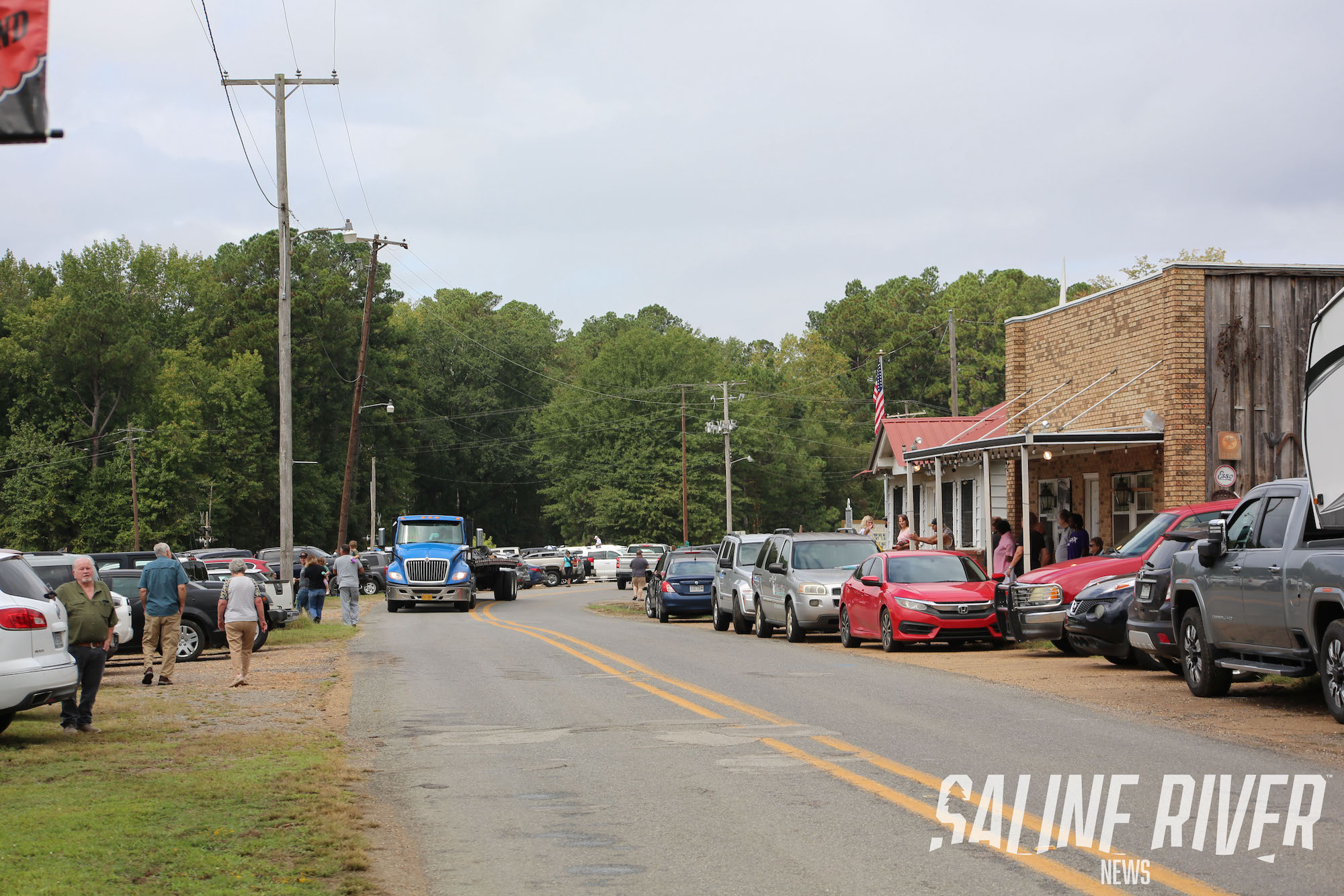 A street with cars parked on the side of it.