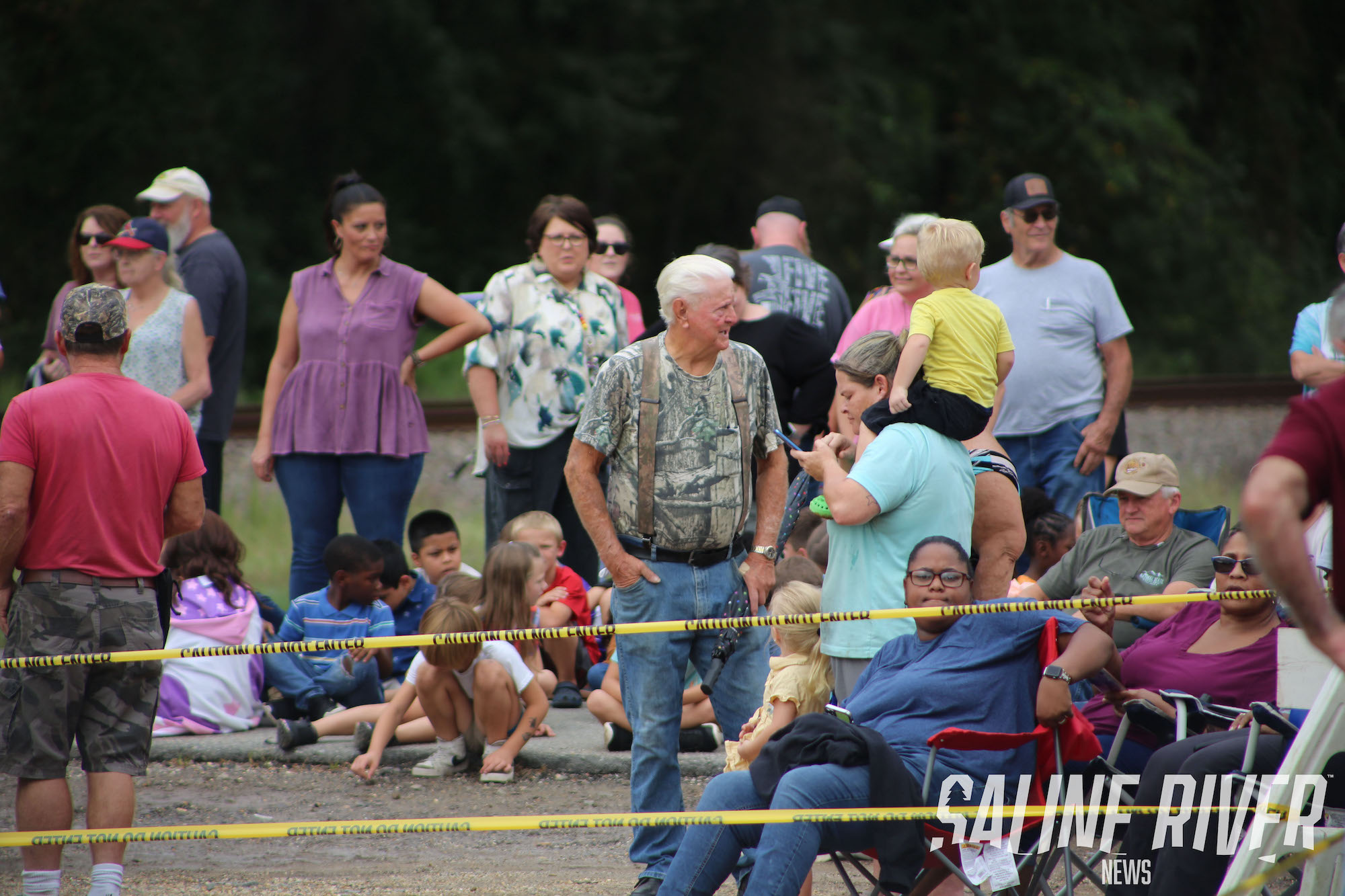 A crowd of people sitting on the ground.