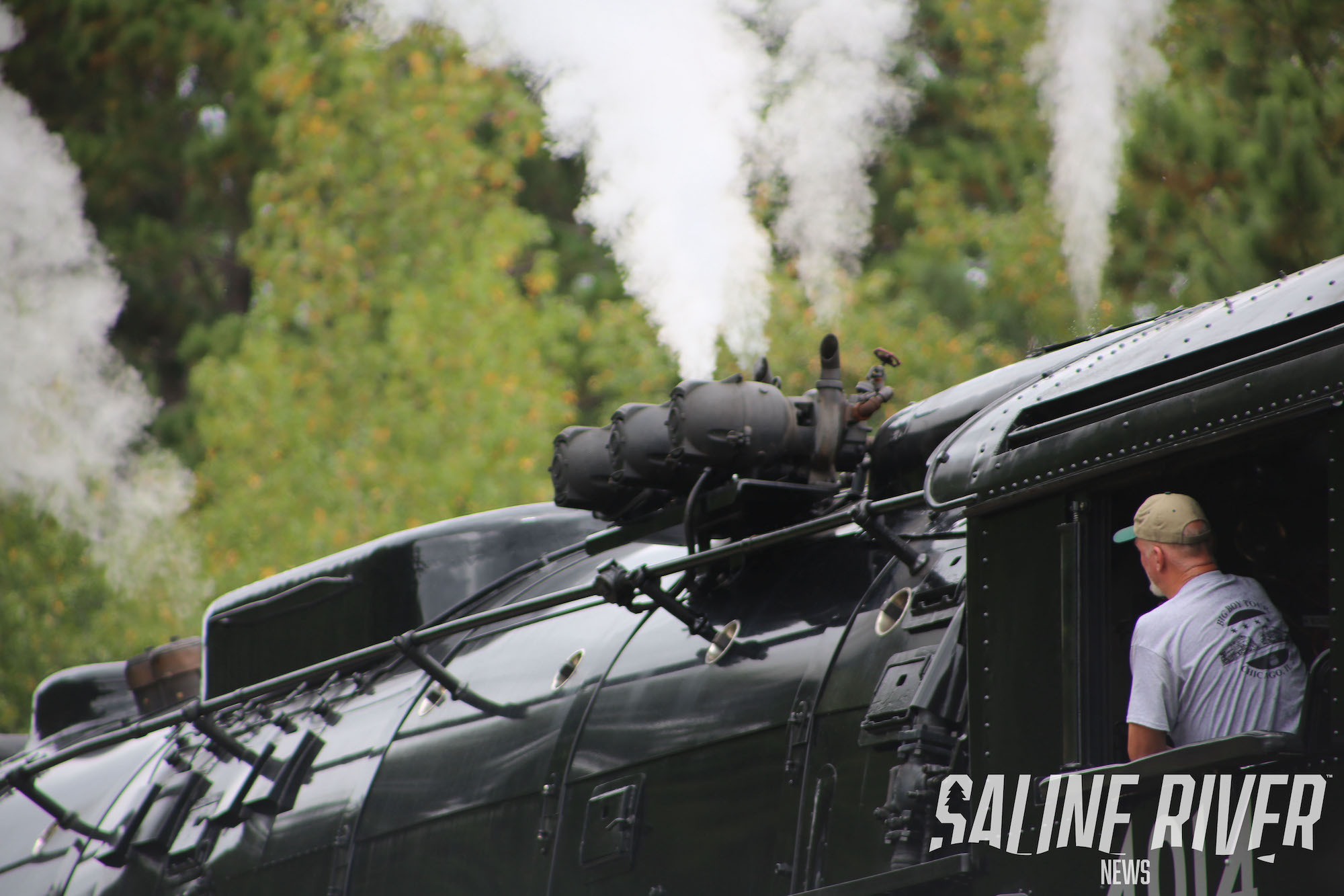 A train engine with smoke coming out of it.