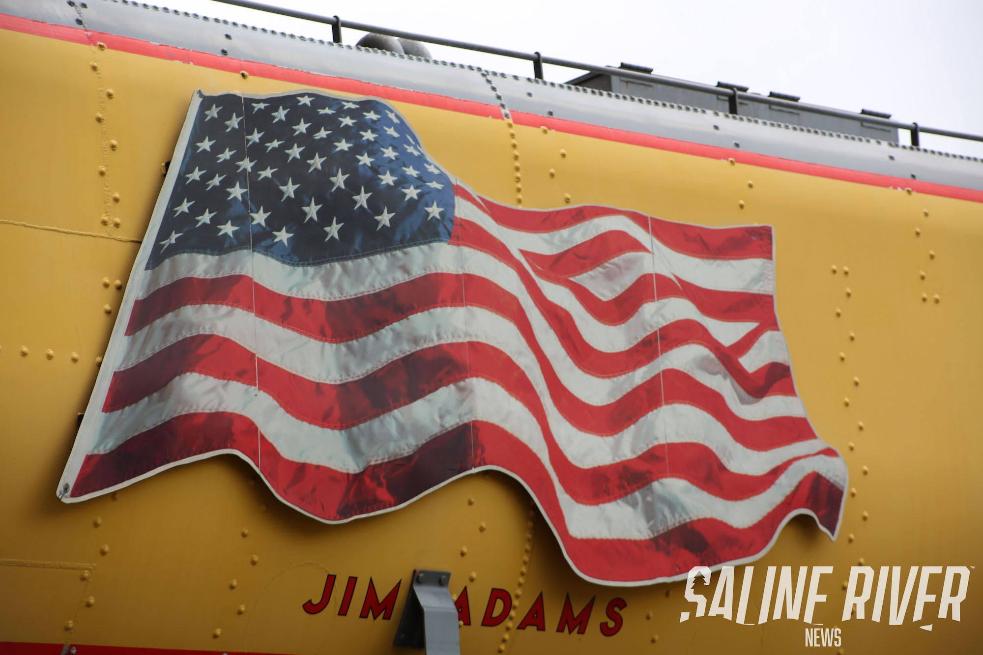 A large american flag on the side of a building.