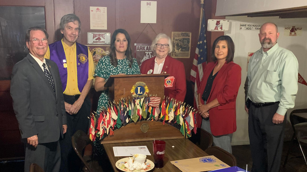 A group of people standing around a table.
