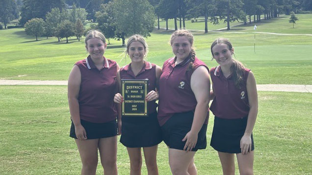 A group of girls holding up a plaque.