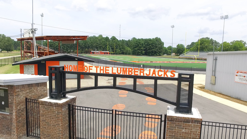 A gate that says house of the lumberjacks.