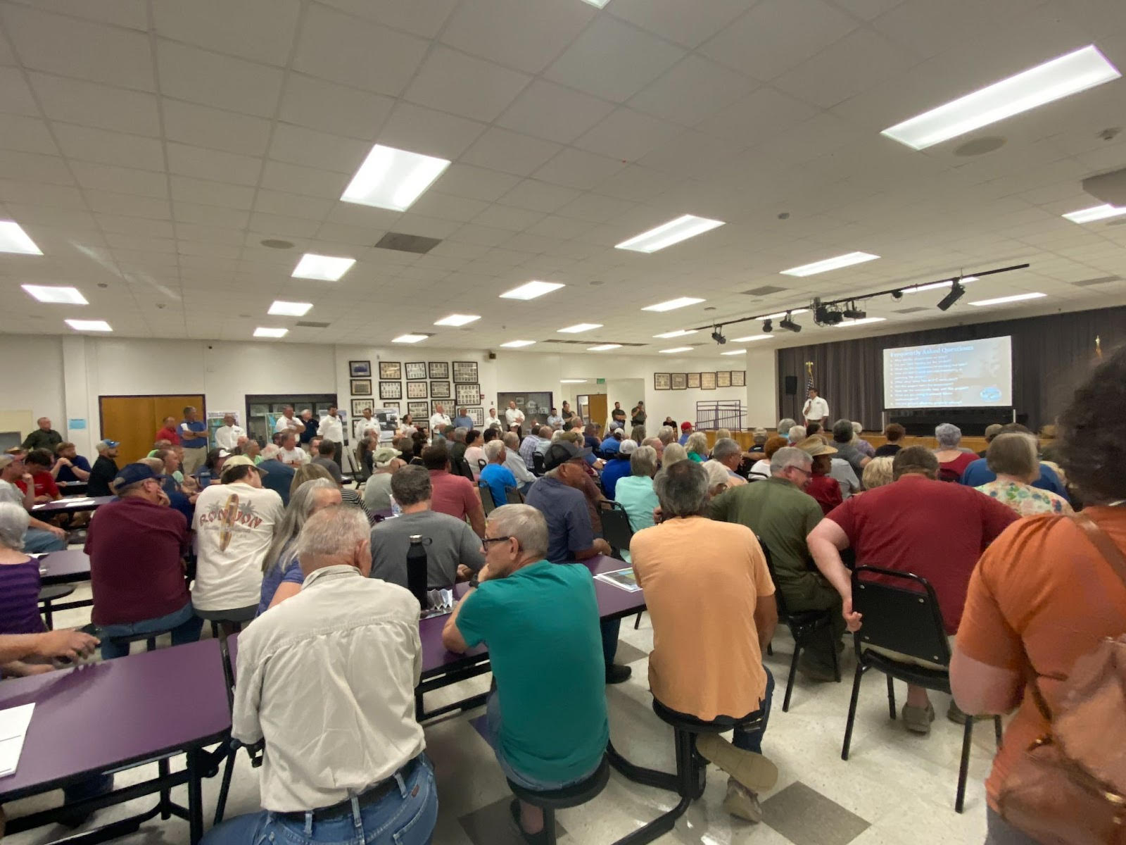 A large group of people sitting at tables.