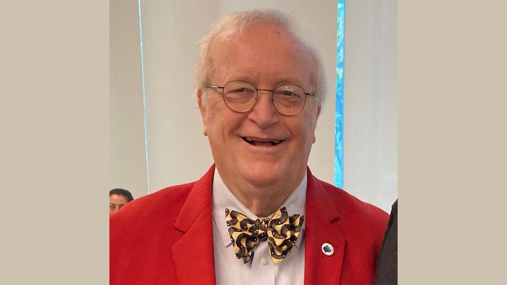 A man in a red jacket and bow tie.