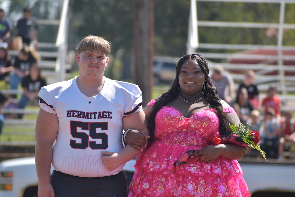 A man and woman in a pink dress