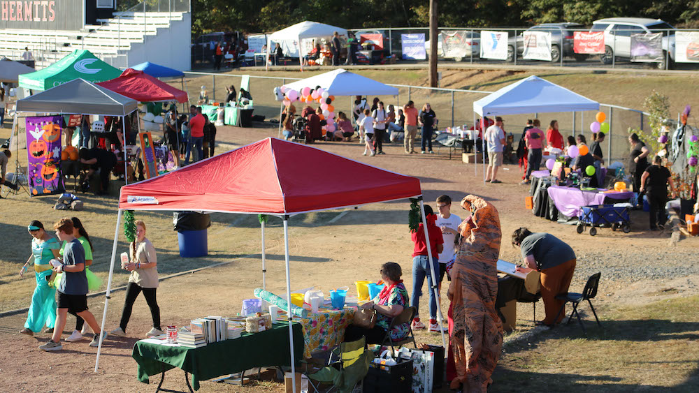 A group of people standing around some tents