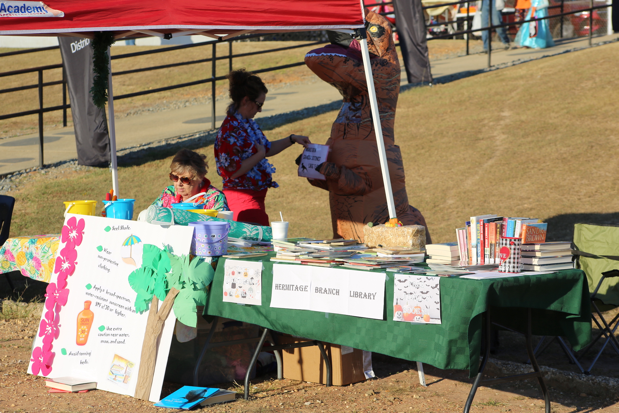 A person in a bear costume at an outdoor event.