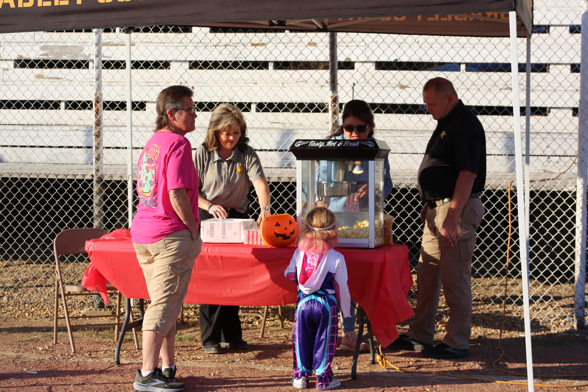 A group of people standing around a table.