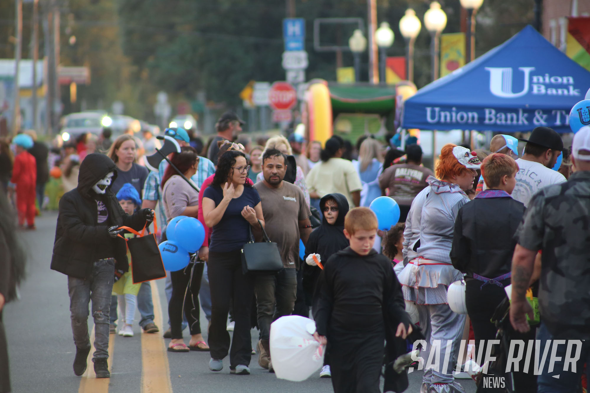 A crowd of people walking down the street.