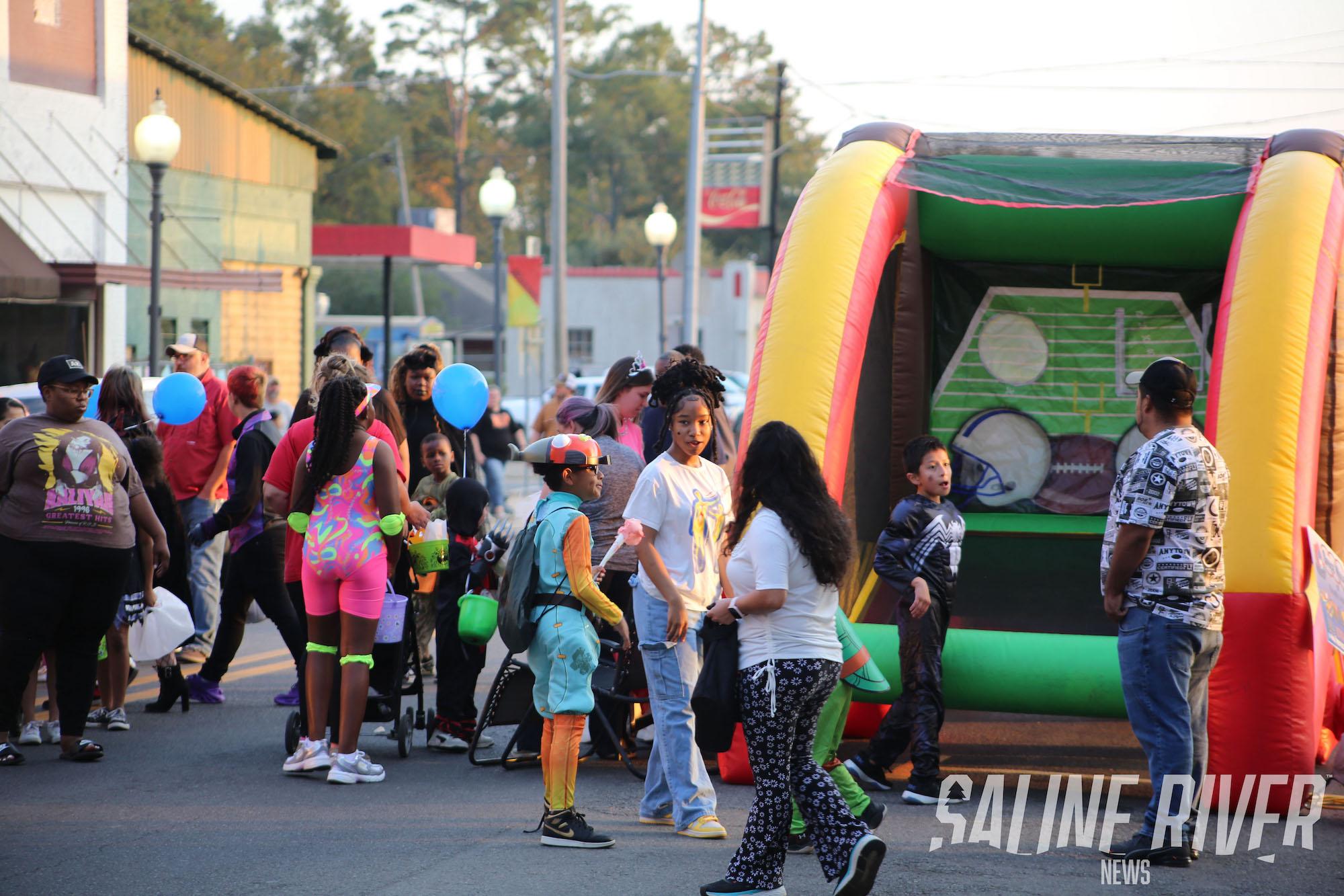 A group of people standing around an inflatable.