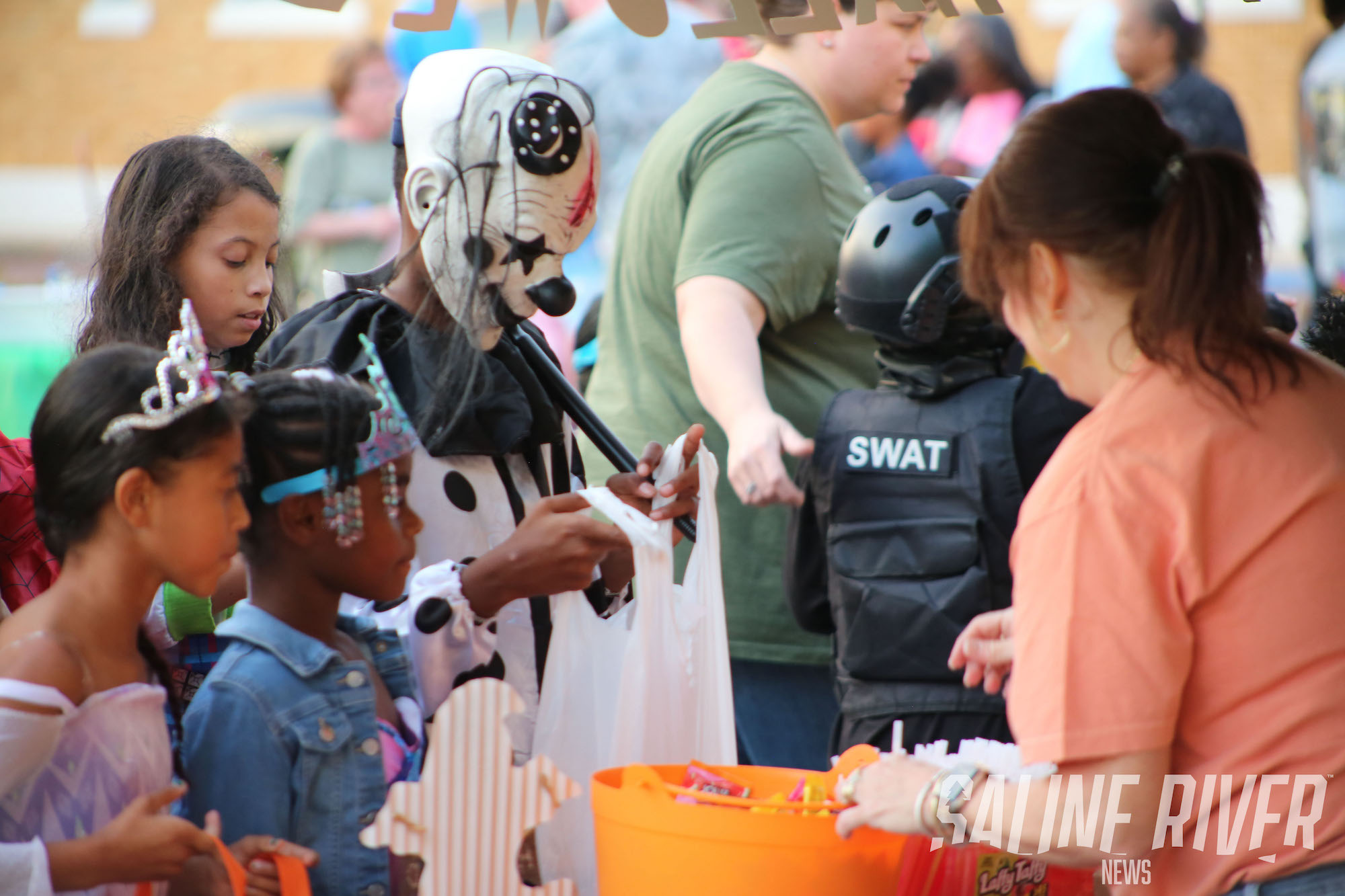 A group of kids in costumes at an event.