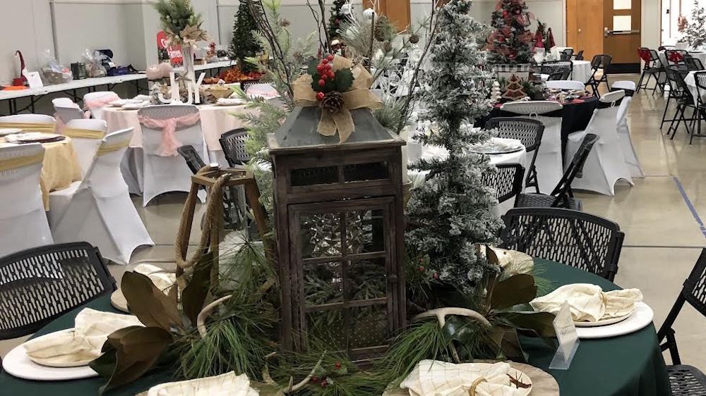 A table with christmas decorations and trees.